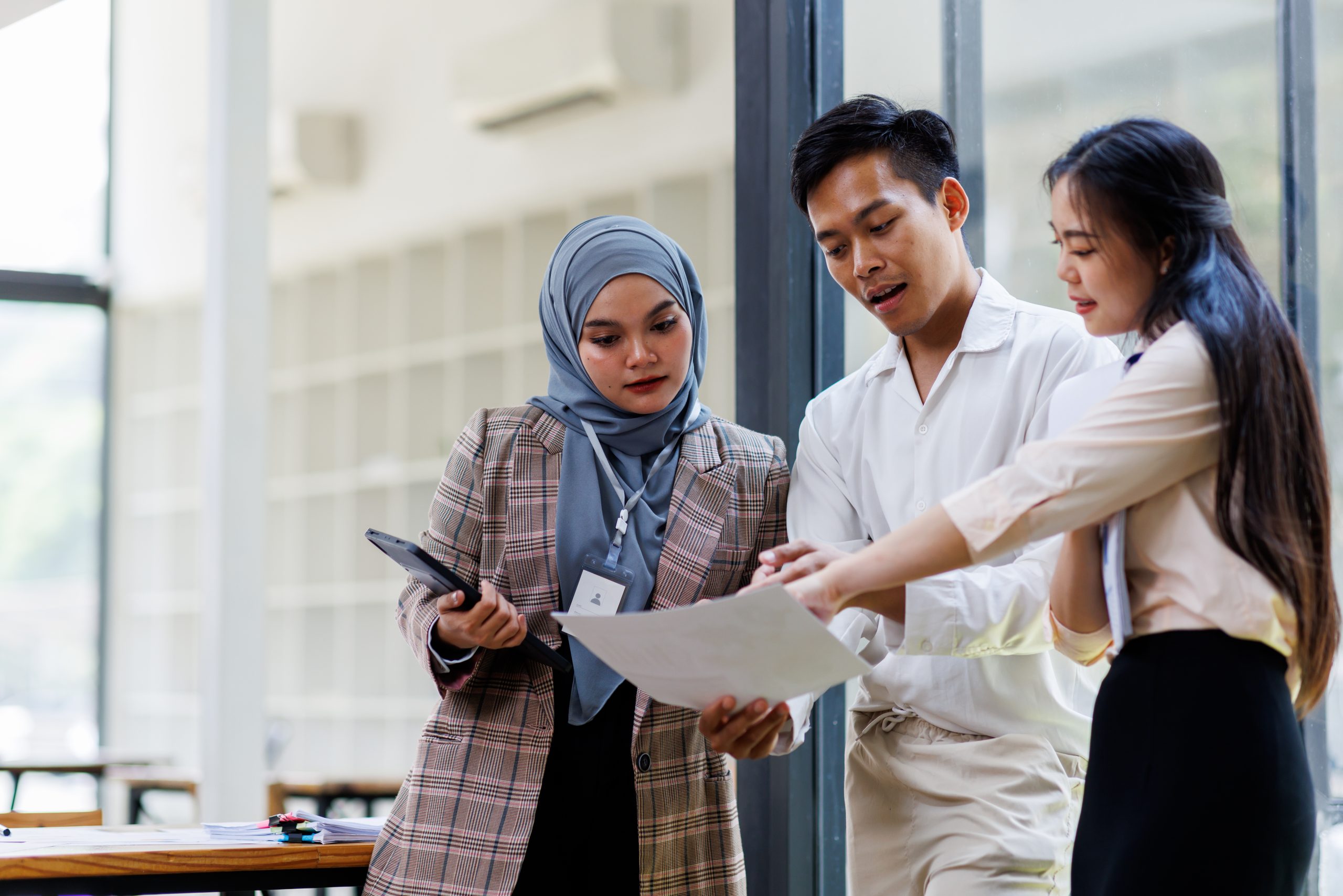 Young business asian colleague discussion with window background Financial Advisor discussion with client.