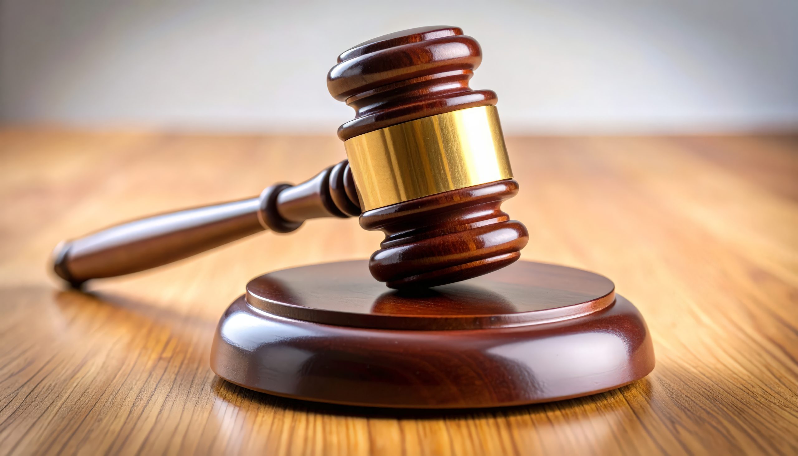 Wooden gavel rests on a polished surface