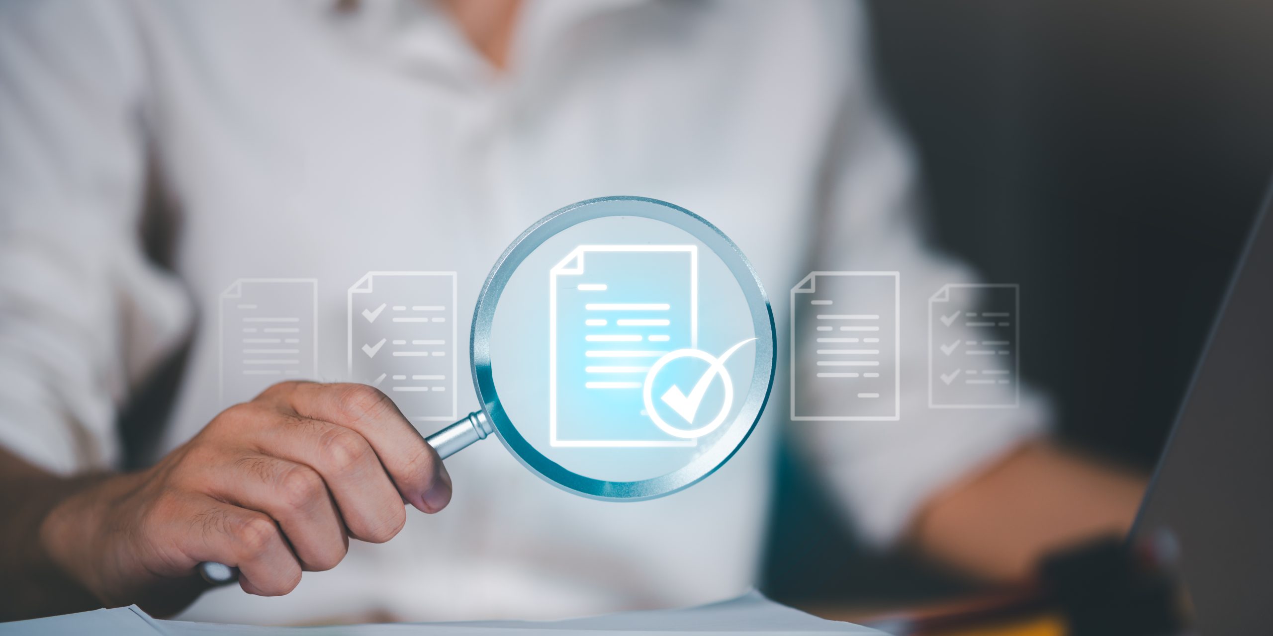 Businessman analyzing documents with magnifying glass and check mark icon, representing document verification, quality assurance, compliance review, and data validation process.
